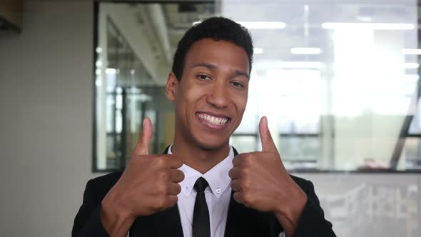 Thumbs Up by Black Businessman in Suit in Office