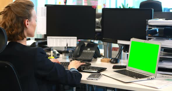 Businesswoman working on computer at desk