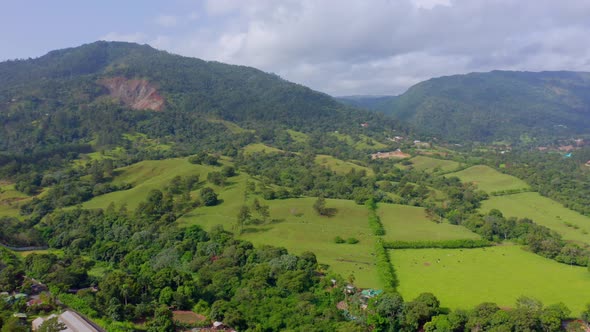 Countryside Landscape With Lush Green Fields And Hills In Jarabacoa, Dominican Republic - aerial dro