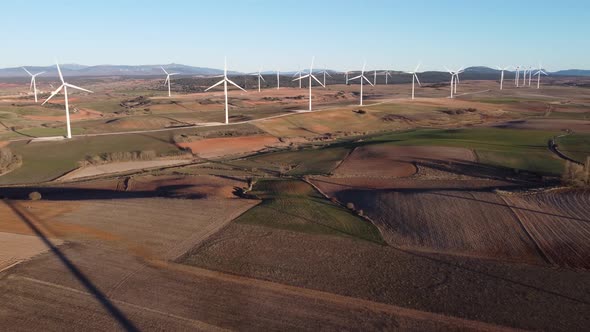 Windmills in field on sunny day