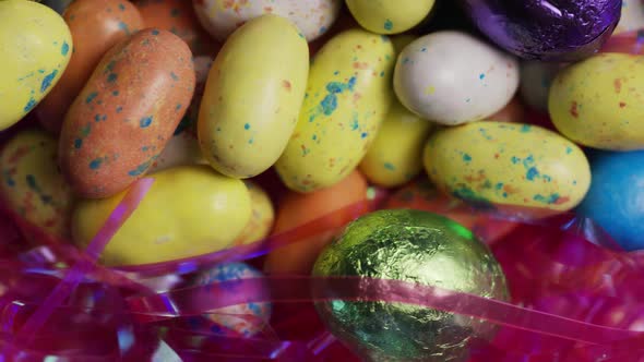 Rotating shot of colorful Easter candies on a bed of easter grass 