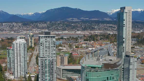 Beautiful drone view of Vancouver's North Shore Mountains in HD from Surrey City Centre on a sunny s