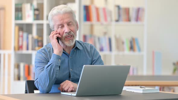 Cheerful Old Man Talking on Smartphone