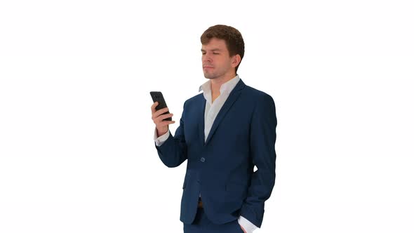 Serious Businessman Looking at His Phone on White Background