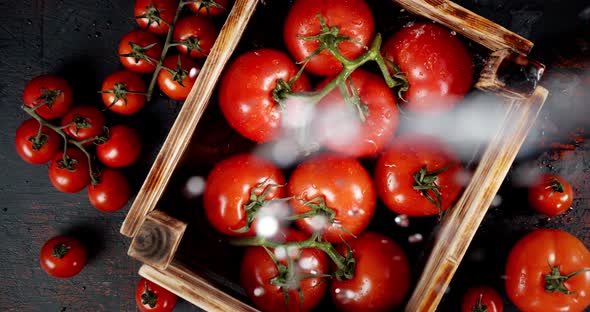 On Ripe Tomatoes in a Wooden Box Falling Water Drops 
