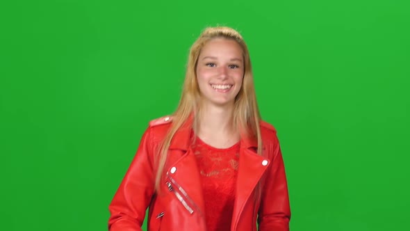 Portrait Blonde Girl Is Running To Meeting with Smile at Green Screen. Chroma Key. Front View. Slow