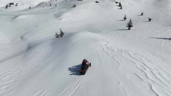 Snowmobile high in the mountains aerial view 4 K