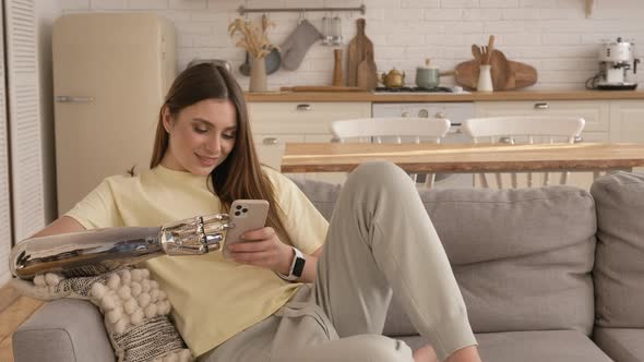 Lady with Bionic Arm Looks Through Social Media Via Phone