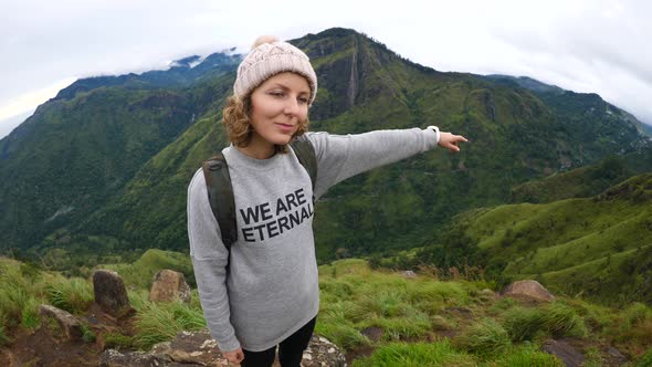 Stylish Hiker Girl Pointing With Her Hand To Mountain Top