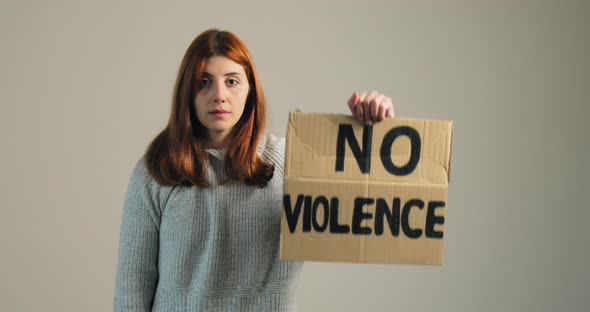 Girl Raises the Billboard That Says No Violence in Protest