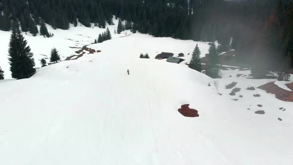 Drone follow shot skiing down a mountain