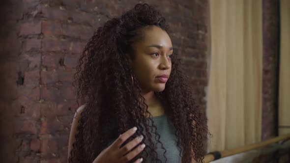 Lovely African American Woman with Curly Hair Indoors