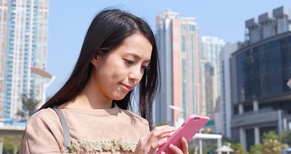 Woman use of smart phone in city