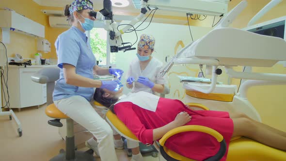 Dentist looking through a microscope