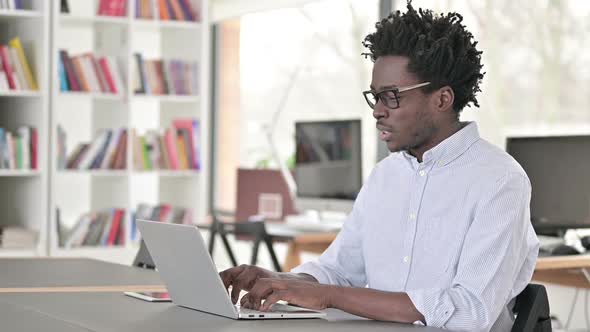 African Man Having Headache at Work