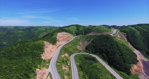 Aerial View of the Landscape of a Winding Curved Road in the Green Mountains