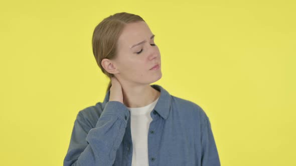 Young Woman Having Neck Pain on Yellow Background
