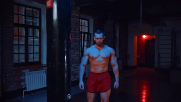 Strong Man Walks To a Camera and Clapping His Hands Covered in Chalk