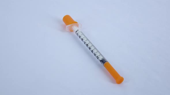 Medical Insulin Syringe on White, Rotation