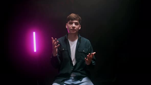 A Young Guy Shoots a Blog in a Black Studio