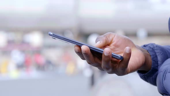 young black african's hand using the smartphone keyboard