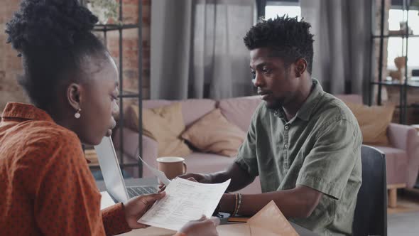 Black Couple Sorting Invoices