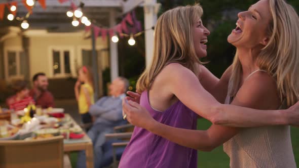 Senior woman hugging her daughter outdoors