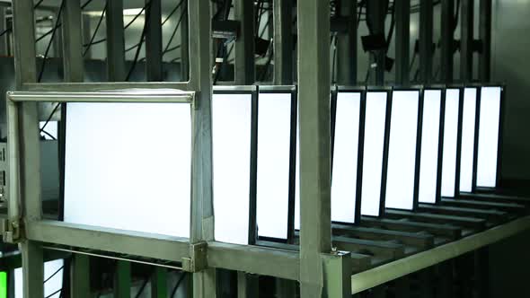 worker is assembling the back of a TV