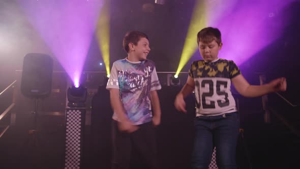 Three Happy Young Boys Dancing at a Party / Disco