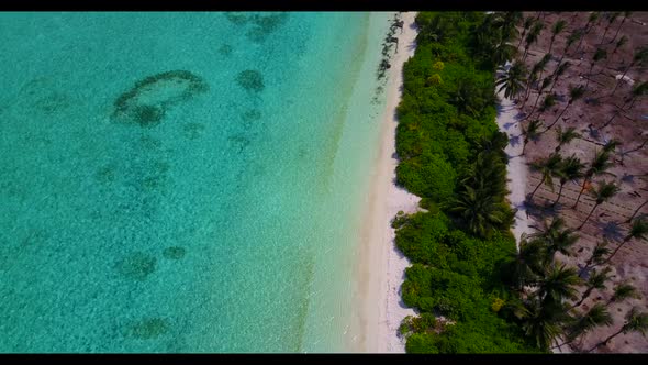 Aerial flying over texture of tropical shore beach time by blue ocean and white sand background of a