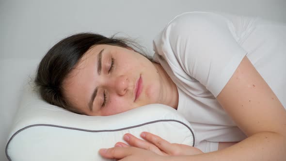 A Woman Sleeps on an Orthopedic Pillow Made of Memory Foam Opens Her Eyes and Smiles