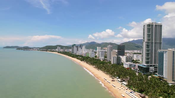 wide aerial view of the coastline in Nha Trang Vietnam on a sunny day with many palm trees along the