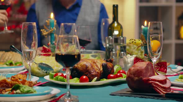 Close Up of Father Slicing the Chicken for His Family