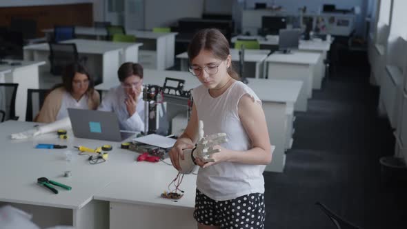 Girl Try to Find the Button to the 3D Printed Hand