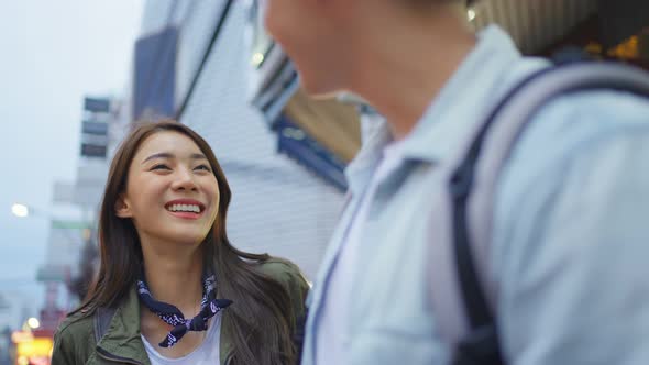 Asian active young couple travel in city for honeymoon trip at night.