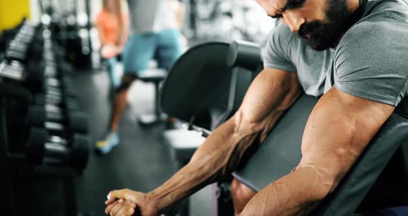 Young Handsome Man Doing Exercises in Gym