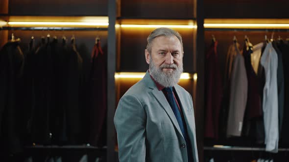 Stylish Confident Rich Mature Businessman Wearing Suit Posing at Own Dressing Room Looking at Camera