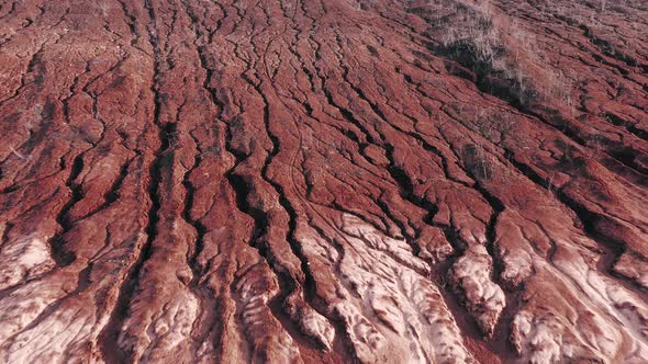 Lots of Deep Cracks on the Surface of the Red Clay Quarry