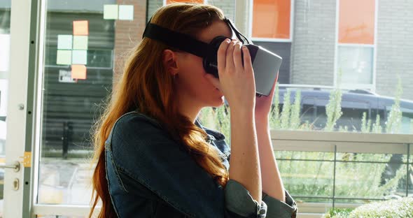 Female executive using virtual reality headset