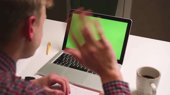 Back View Close Up Man Waving Hand on Camera Laptop Green Screen Chromakey Man Has Video Call