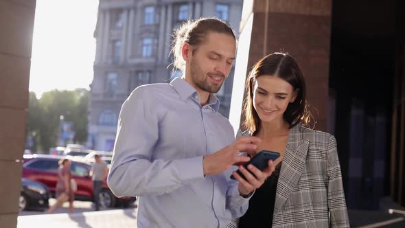 People, Technology. Business Man And Woman Using Phone Outdoors