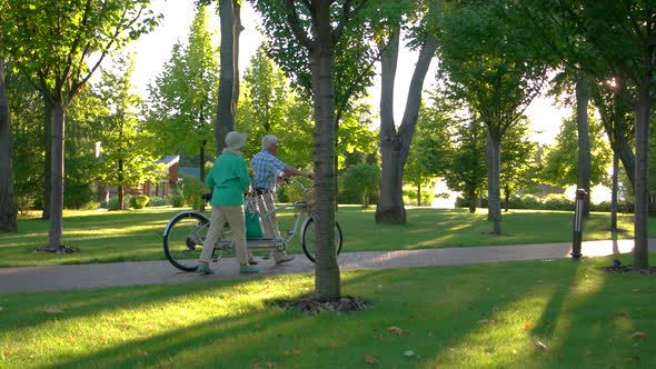 Couple Walking with Bicycle.