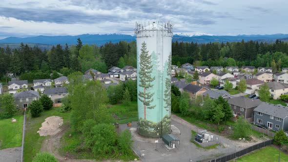 Aerial shot of a water tower surrounded by a suburban neighborhood.