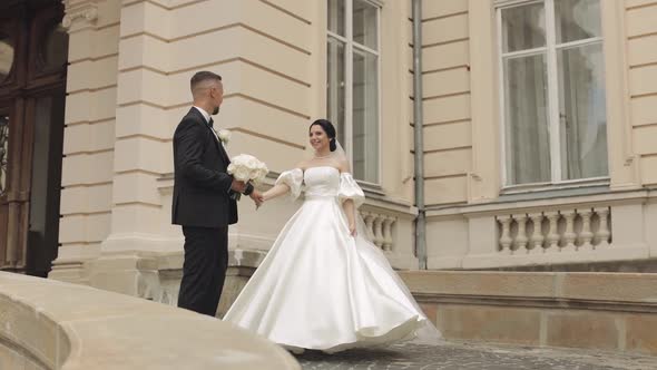 Newlyweds Portrait Caucasian Groom Bride Walking Embracing Hugs Near Old Castle Wedding Couple
