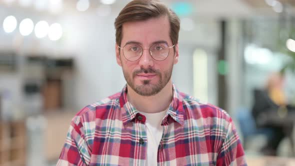 Portrait of Serious Male Designer Looking at Camera 