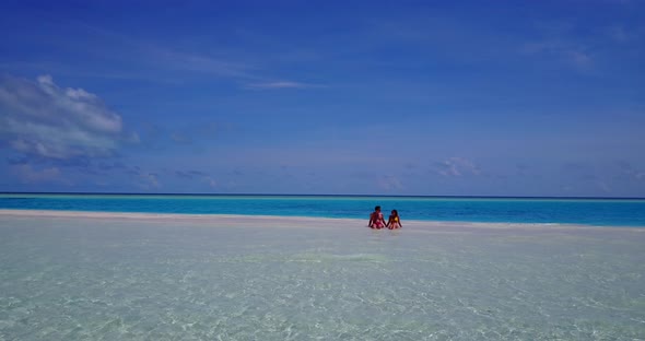 Happy lady and man on honeymoon vacation live the dream on beach on white sand background 4K