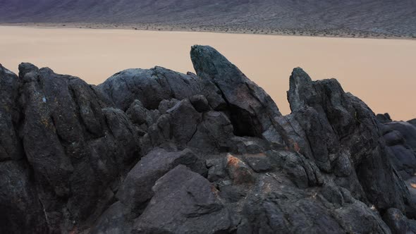 Wild Nature and Outdoor Motion Background. Scenic Black Rocks on the Lake Bed 