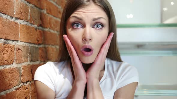 Portrait of Shocked Young Woman Amazed By Surprise