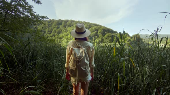 Young girl in a hat walking in a national park