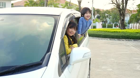 Happy Asian Children Sitting In The Car